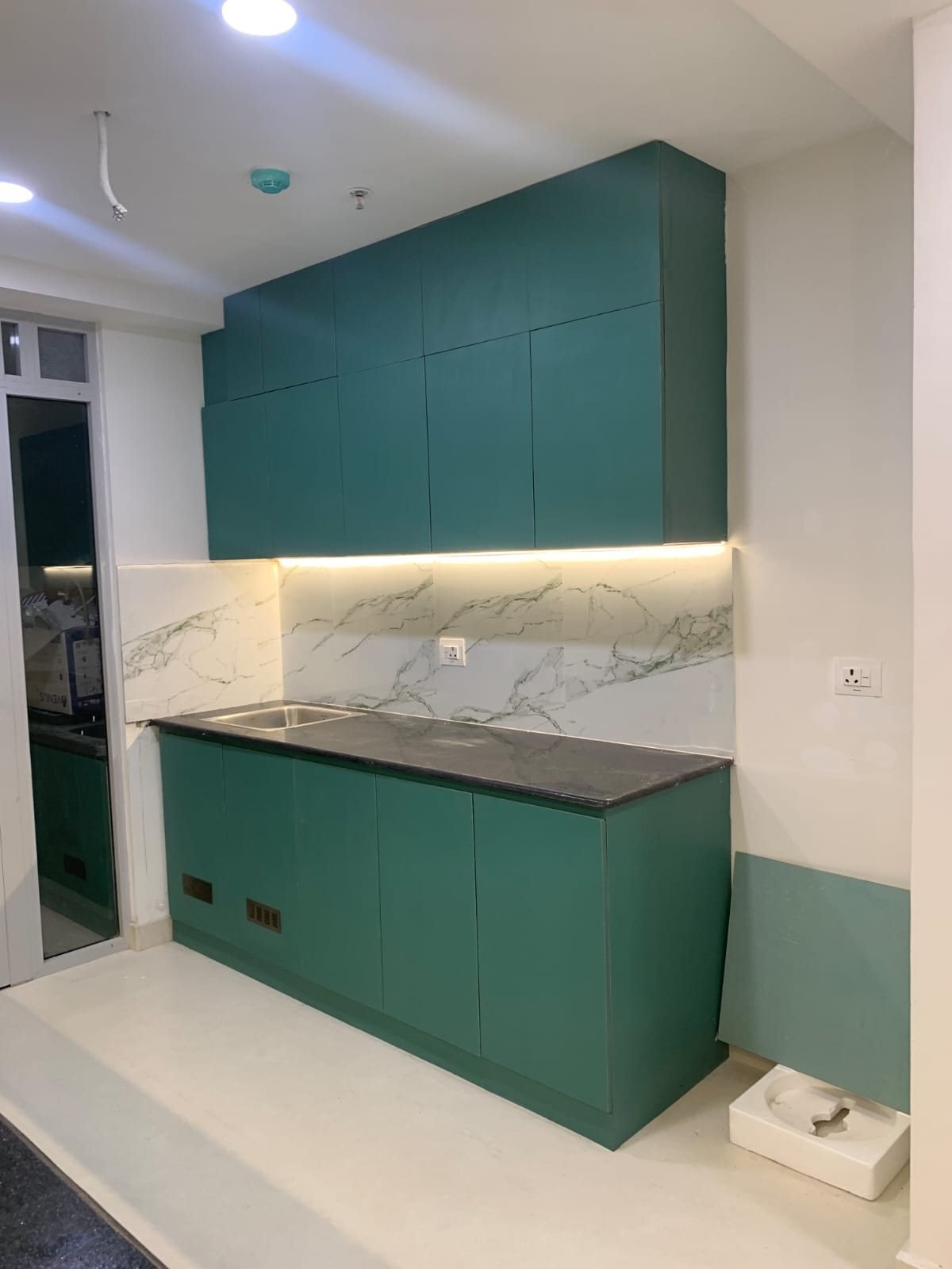 Modular kitchen with sage green and cream cabinets